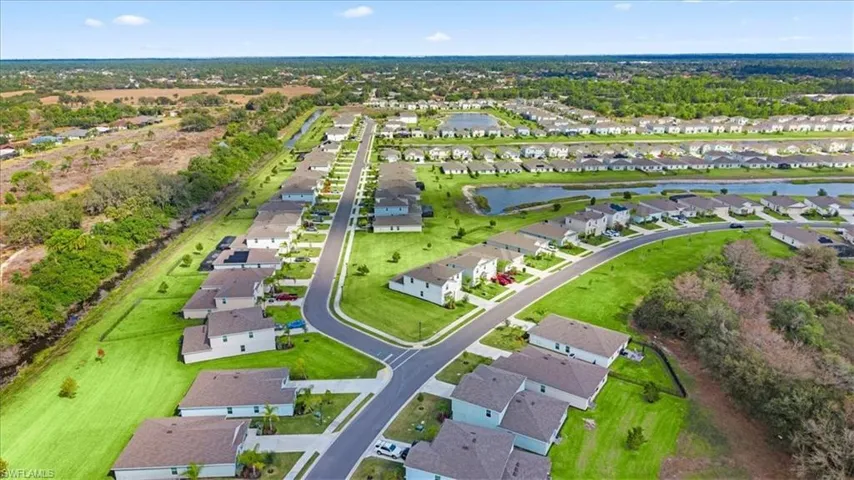 Aerial view of property's location featuring nearby suburban area and a nearby body of water