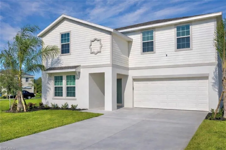 View of front of property featuring an attached garage, stucco siding, concrete driveway, a front lawn, and a shingled roof
