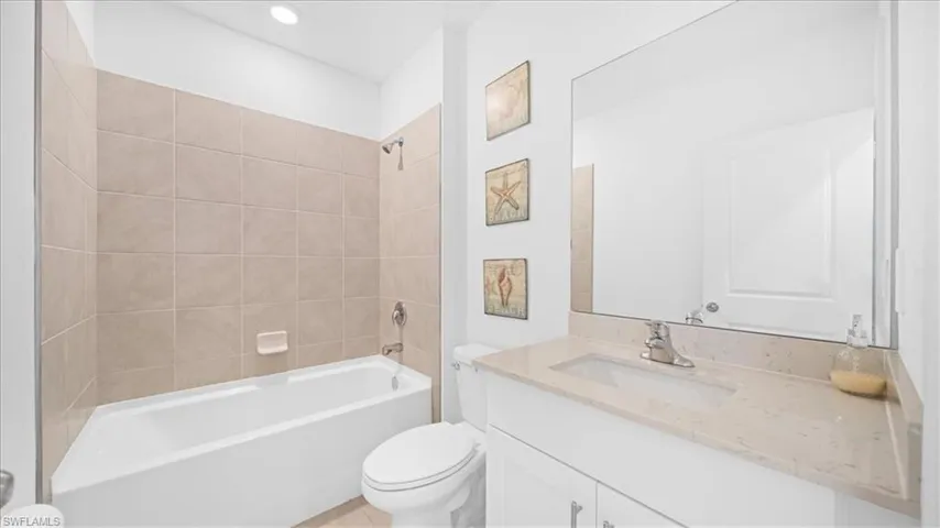 Full bathroom with vanity, shower / washtub combination, and recessed lighting