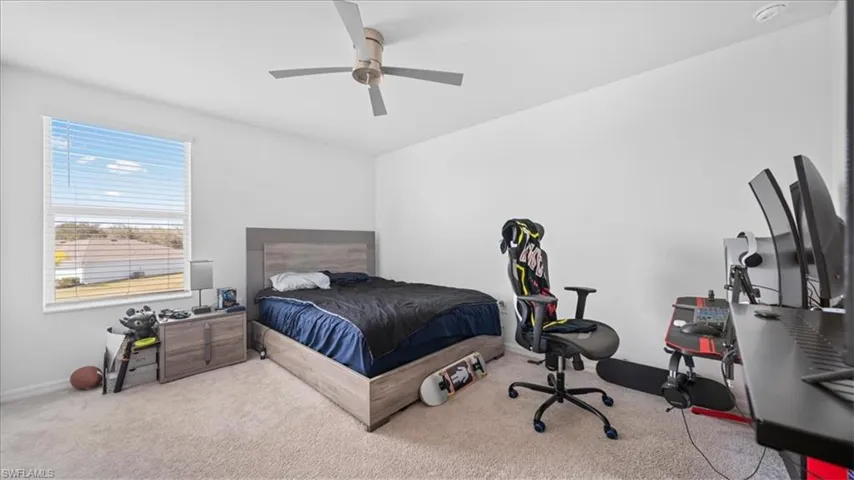 Bedroom featuring light carpet and ceiling fan