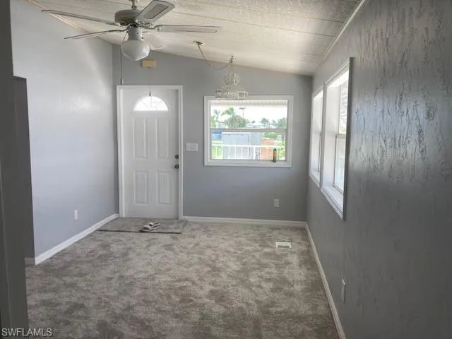 carpet floors, a ceiling fan, and lofted ceiling
