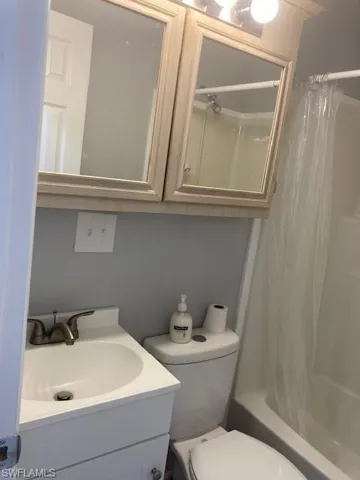 Full bath featuring shower / tub combo and vanity