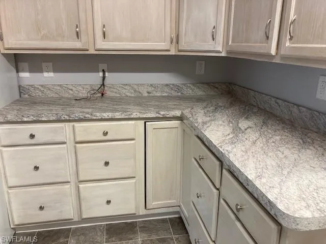 Kitchen featuring light brown cabinetry and light countertops