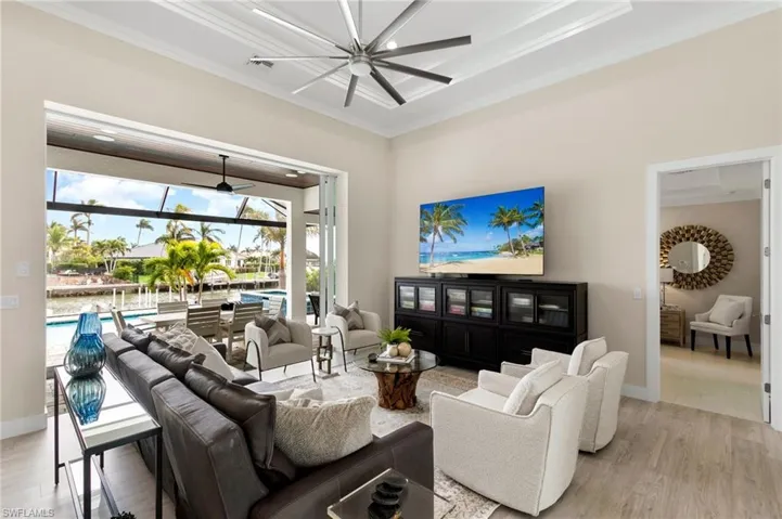 Living room with crown molding and light hardwood / wood-style flooring