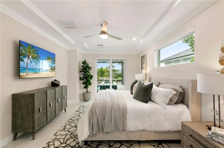 Bedroom with ceiling fan, ornamental molding, light tile patterned floors, and access to exterior