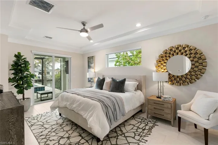 Tiled bedroom featuring access to exterior, ceiling fan, crown molding, and multiple windows