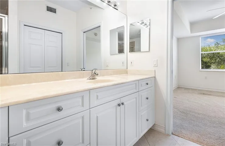 Master Bathroom with Vanity and Tile Patterned Floors!
