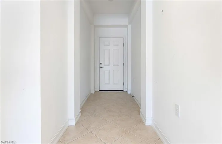 Hallway to Your Future Front Door with Light Tile Flooring on the Diagonal.