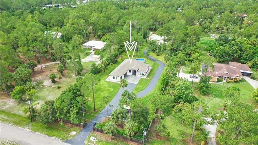 View of subject property with a heavily wooded area