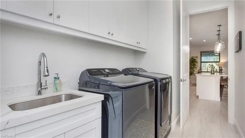 Laundry room featuring cabinet space and washing machine and clothes dryer