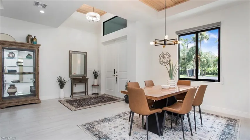 Dining room featuring a chandelier, light wood-style flooring, and recessed lighting