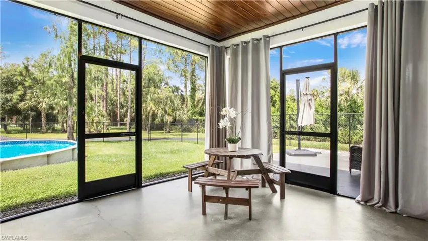 Sunroom / solarium with view of scattered trees
