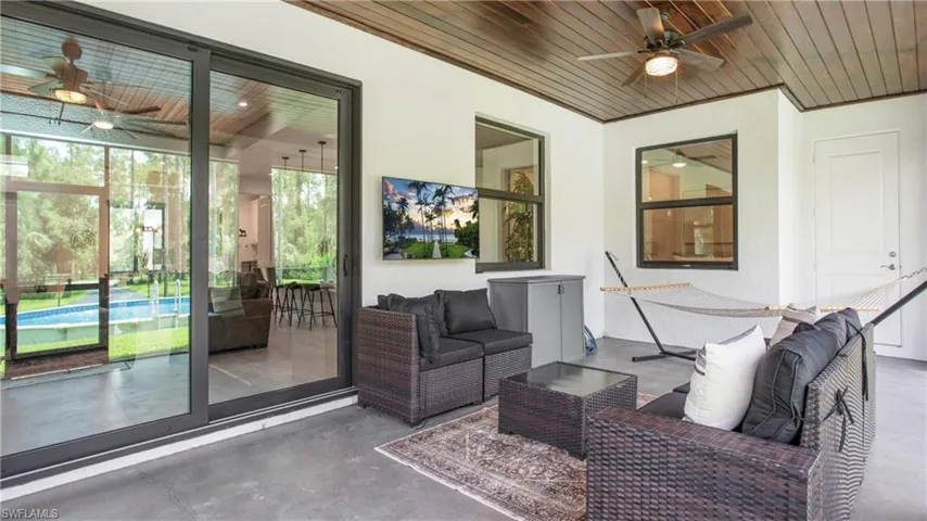 View of patio / terrace with ceiling fan, an outdoor hangout area, and an outdoor pool
