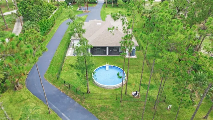 View of subject property with a pool area
