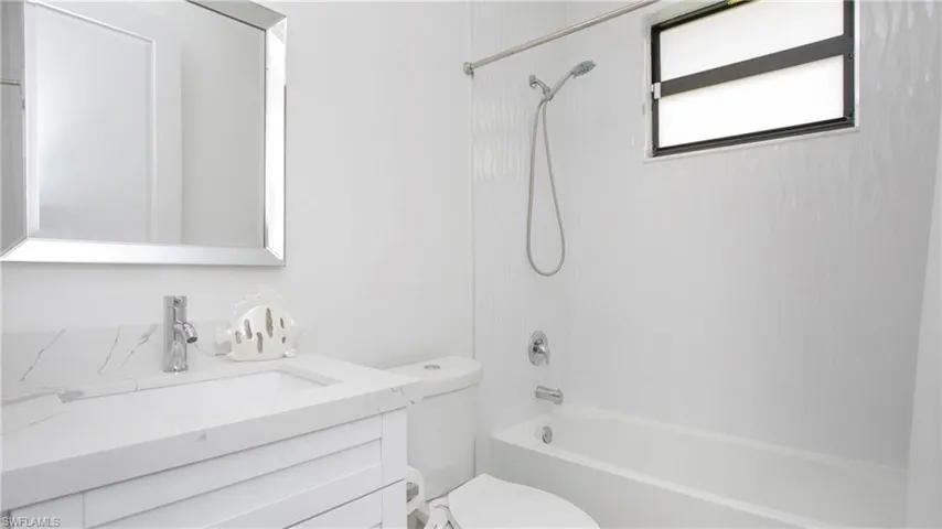 Bathroom with vanity and shower / tub combination