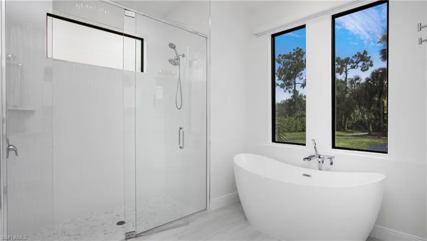 Full bath featuring a freestanding bath and a stall shower