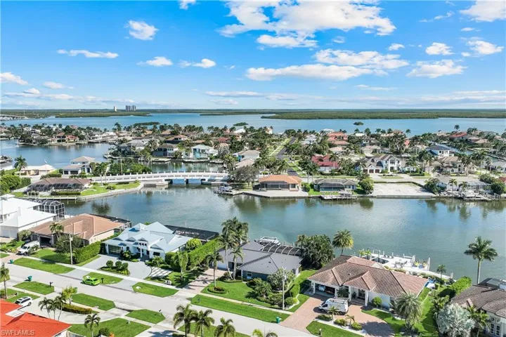 Aerial perspective of suburban area featuring a large body of water