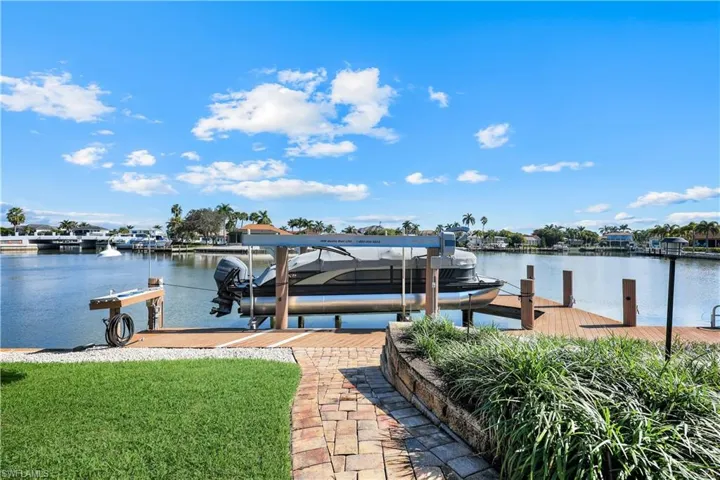 Dock area with a water view and boat lift