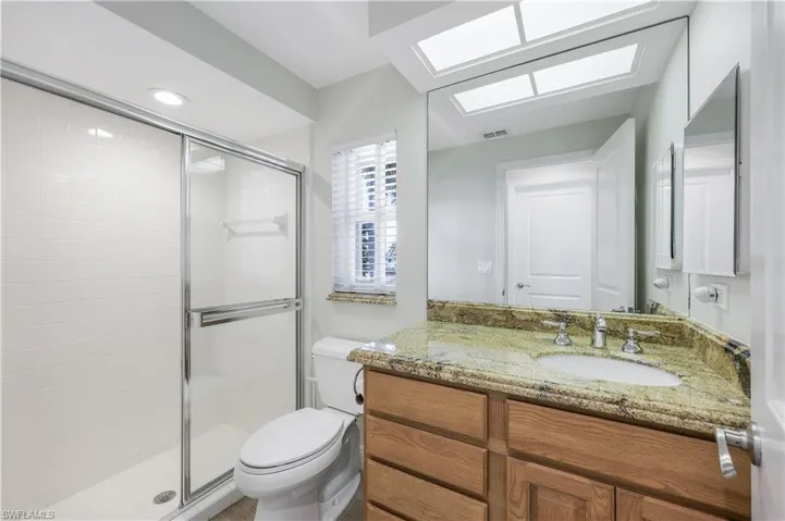 Bathroom featuring vanity, a stall shower, and recessed lighting