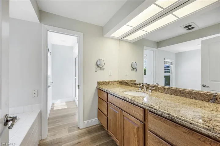 Bathroom with light wood-style flooring and vanity