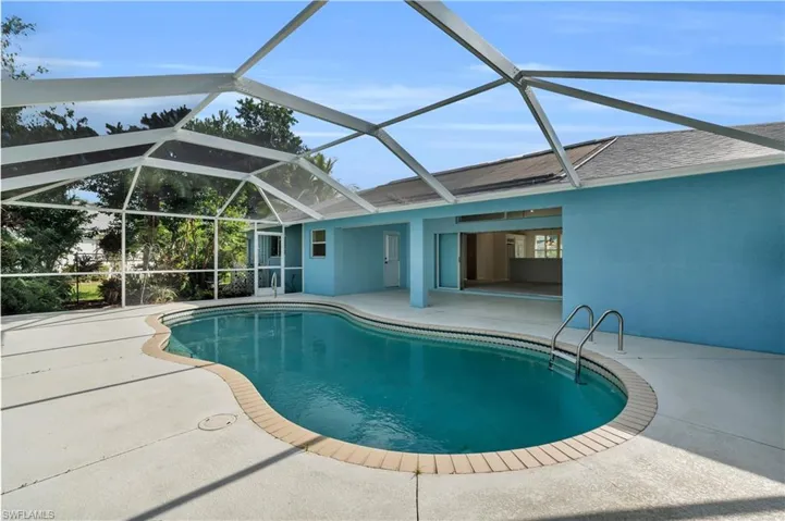 View of swimming pool featuring a patio and a lanai