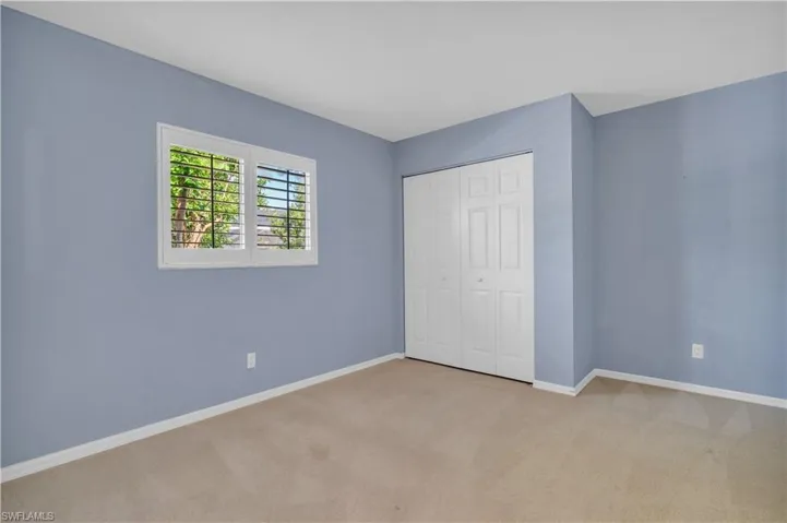 Unfurnished bedroom with a closet and carpet floors