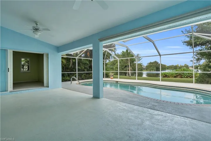 View of swimming pool featuring ceiling fan