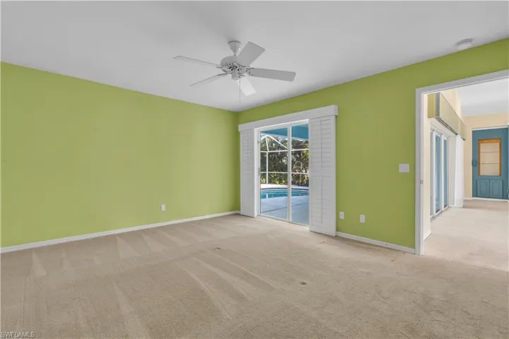 Carpeted spare room with ceiling fan
