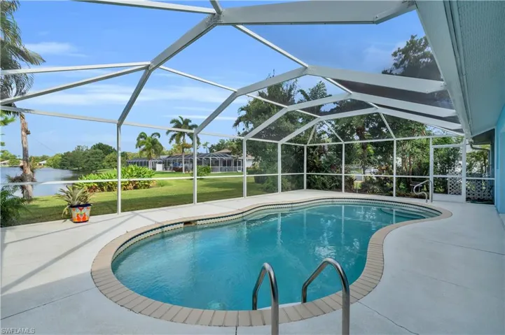 View of pool featuring a yard, a patio area, and a lanai