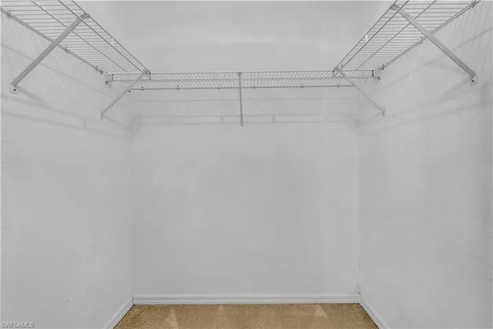 Spacious closet with carpet flooring