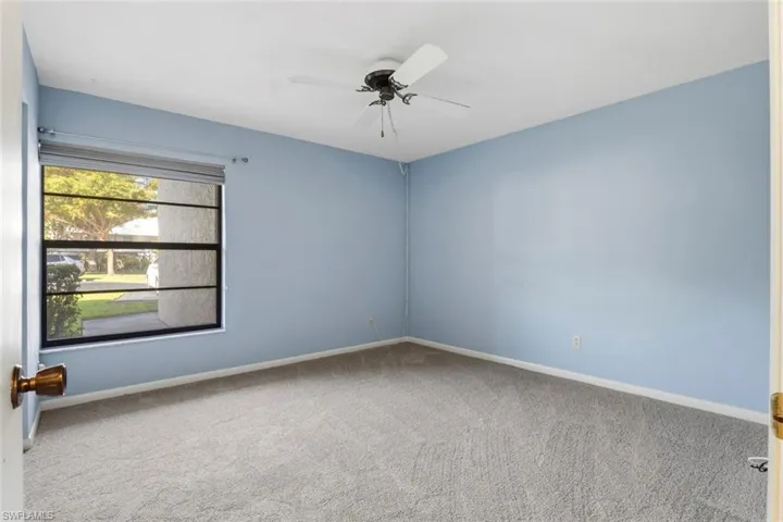 Guest bedroom with ceiling fan and new carpet