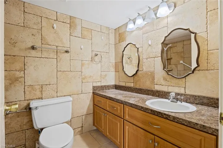 Full bath with vanity and a tile shower