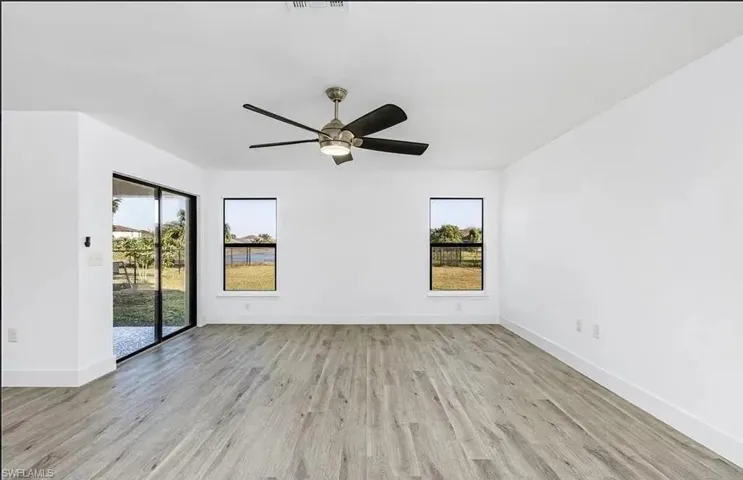 Empty room featuring light wood-style flooring and ceiling fan