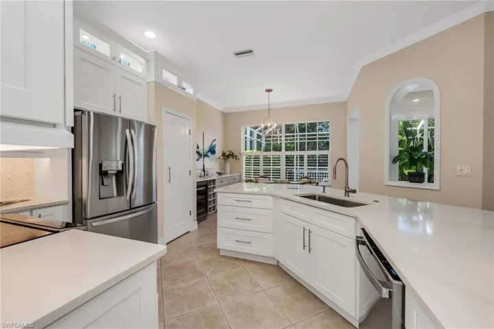Quartz countertops, stainless appliances, pantry with pull out drawers, built-in in breakfast area.  Tropical paradise beyond!