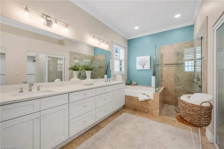 Zen style primary bathroom. Dual sinks, soaking tube, and seamless glass shower enclosure.