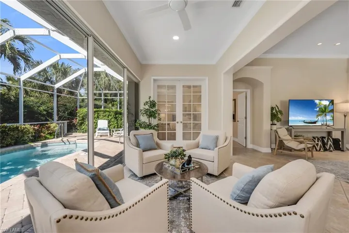 Sun Room has sliders that open all the way to the wall and have access to the pool and lanai area.  Great conversation area to relax and enjoy the peaceful tropical surroundings beyond