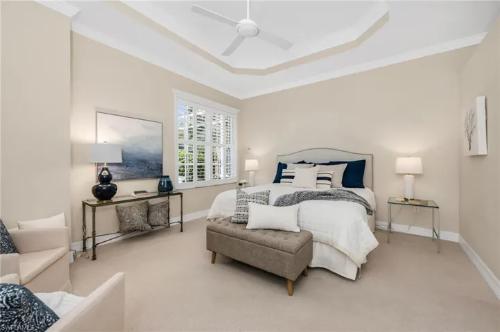 Coffered ceiling in Primary Bedroom, plenty of room for sitting area, and neutral palette creates endless possibilities.