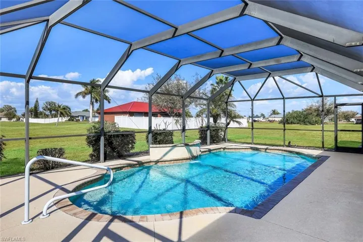 Outdoor pool with glass enclosure, a sunroom, and a patio