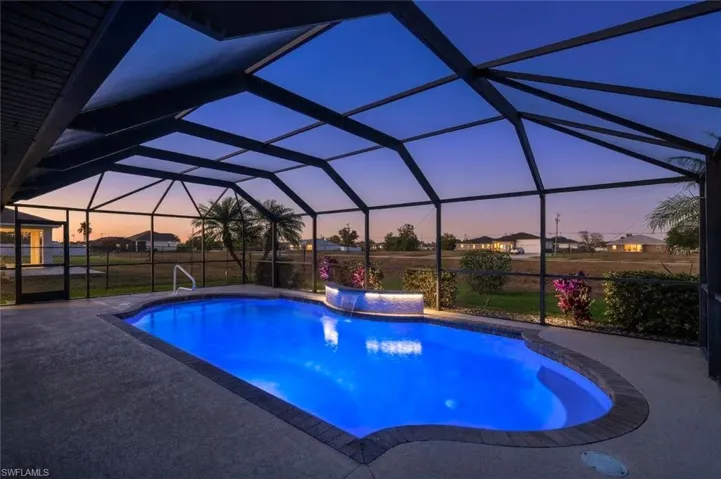 Swimming pool with a sunroom, glass enclosure, and a patio