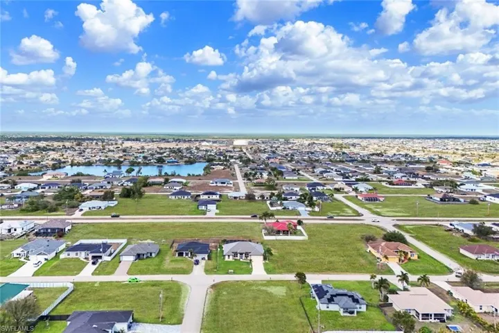 Aerial perspective of suburban area featuring a large body of water