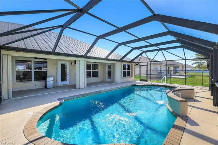 Swimming pool featuring a patio, a sunroom, and glass enclosure
