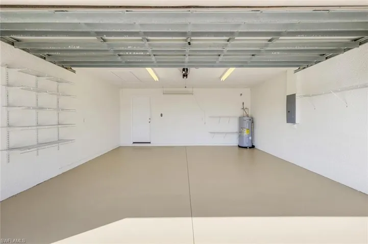 Garage with water heater and electric panel