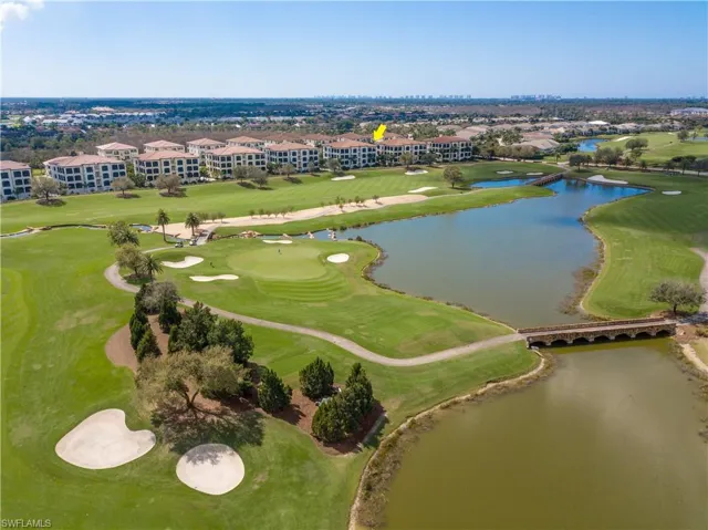 Aerial view of residential area with a local golf course and a large body of water