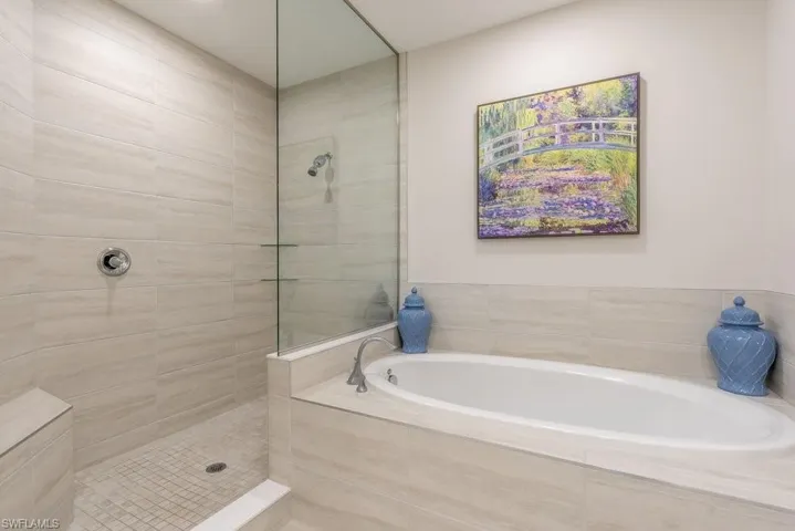 Full bathroom featuring walk in shower and a bath
