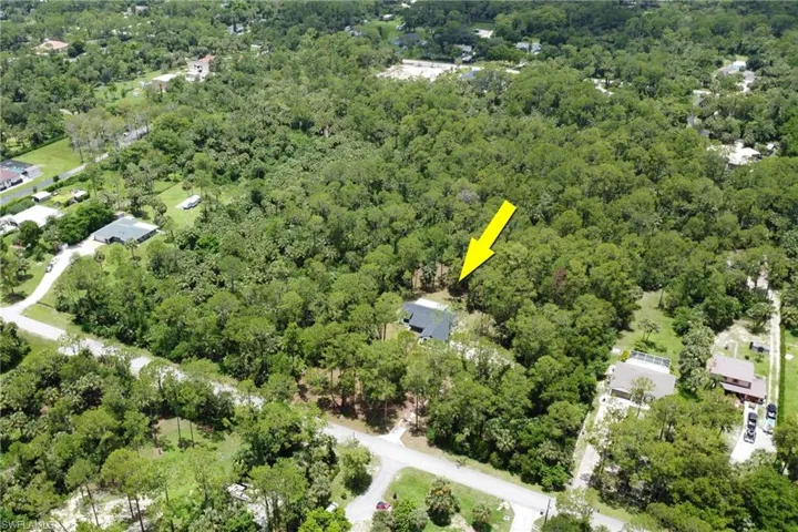 Aerial overview of property's location featuring a heavily wooded area
