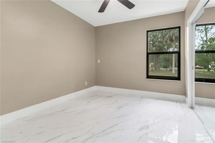 Empty room with ceiling fan and marble finish flooring
