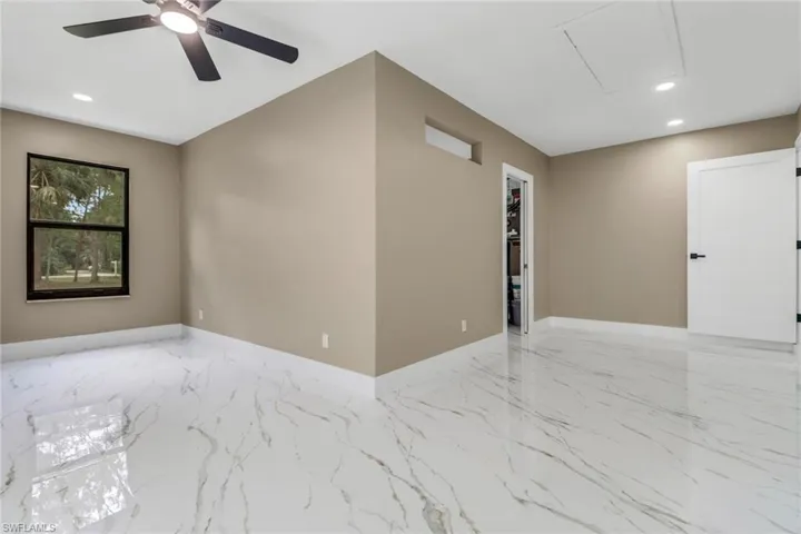Unfurnished room featuring marble tiled flooring, recessed lighting, and a ceiling fan