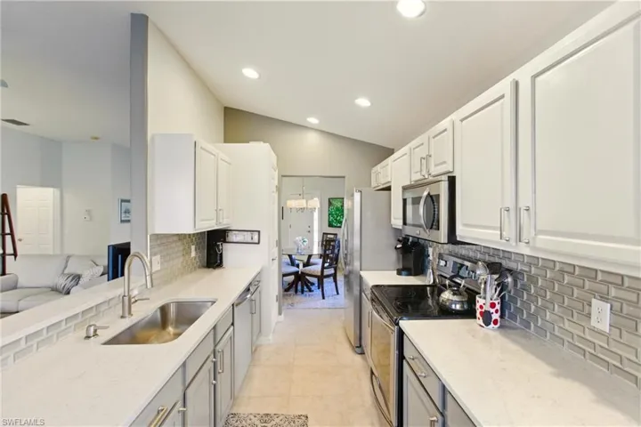Newly renovated Quartz Kitchen with glass backsplash and beautiful stylish cabinets