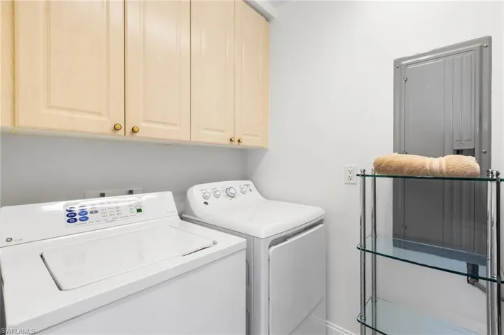 Laundry room has extra storage.