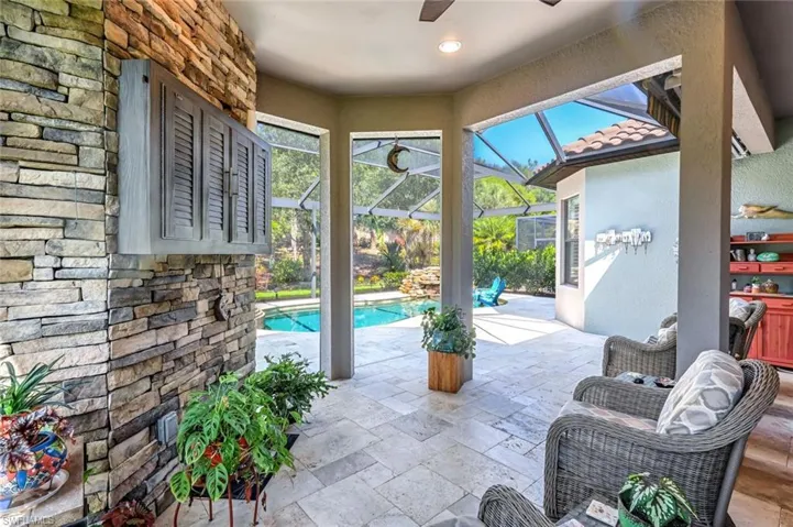 View of patio featuring a ceiling fan, an outdoor pool, and a lanai
